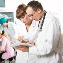 Doctor giving notes to the nurse